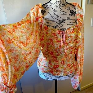NWT Free People rauched with tie elastic back, puff sleeve, open back blouse